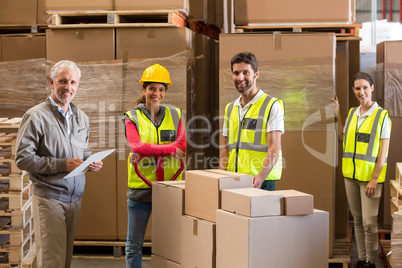 Portrait of warehouse manager and workers preparing a shipment