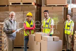Portrait of warehouse manager and workers preparing a shipment