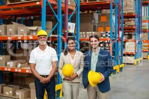 Portrait of warehouse managers and worker standing together