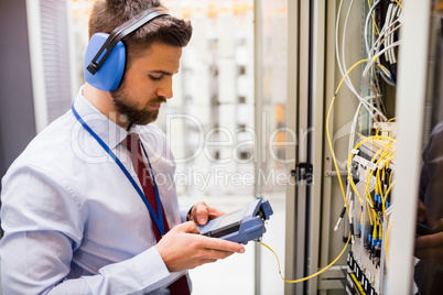 Technician using digital cable analyzer