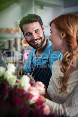 Happy couple arranging flowers