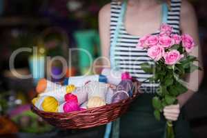 Female florist holding bunch of flower in flower shop
