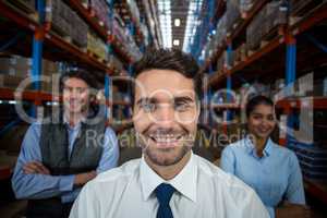 Portrait of warehouse team standing with arms crossed