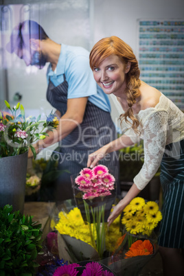 Couple arranging flower bouquet
