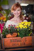 Female florist holding crate of flower bouquet