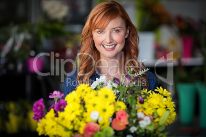 Female florist standing and smiling