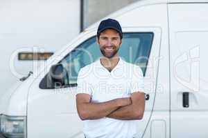 Portrait of delivery man standing with arms crossed