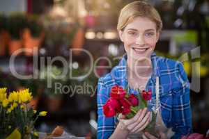 Female florist holding flower bouquet