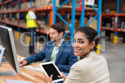 Portrait of smiling manager using digital tablet