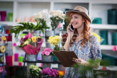 Female florist taking order on mobile phone