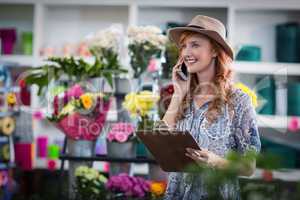 Female florist taking order on mobile phone