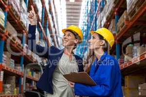 Warehouse manager and worker checking the inventory