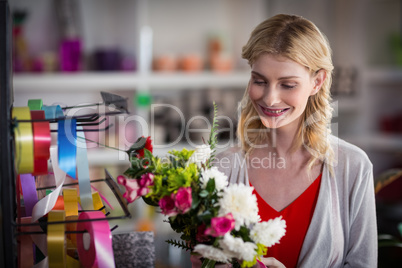 Female florist preparing a flower bouquet