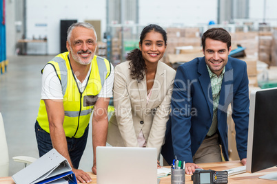 Portrait of warehouse managers and worker working together