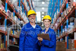 Warehouse workers standing together in warehouse