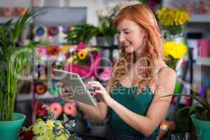 Female florist using digital tablet in florist shop