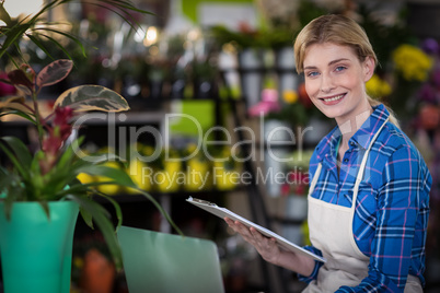 Female florist holding clipboard