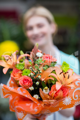 Female florist holding flower bouquet