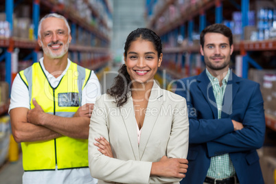 Portrait of warehouse team standing with arms crossed