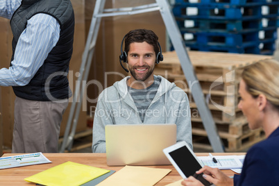 Man using laptop in warehouse