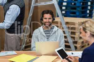 Man using laptop in warehouse