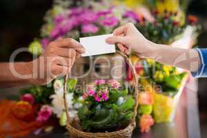 Florist giving visiting card to customer