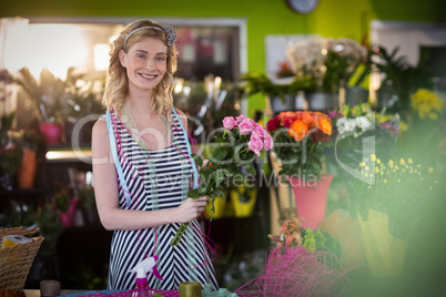 Female florist preparing flower bouquet