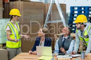 Warehouse worker interacting with manager