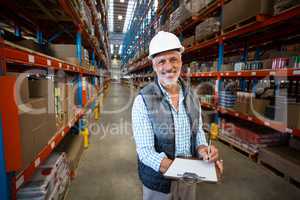 Warehouse worker holding clipboard