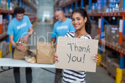 Portrait of woman holding sign boards with thank you message