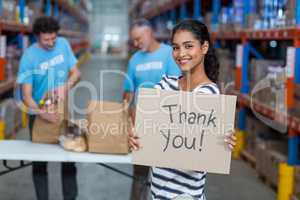 Portrait of woman holding sign boards with thank you message