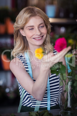 Female florist arranging flower in vase