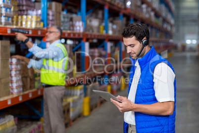 Warehouse worker using digital tablet