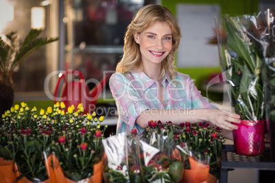 Happy female florist preparing a flower bouquet