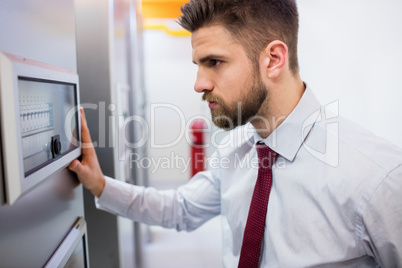 Technician looking at server cabinet