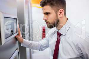 Technician looking at server cabinet