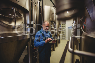 Owner using digital tablet at brewery