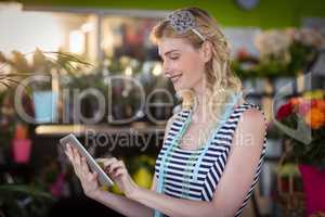 Female florist using digital tablet