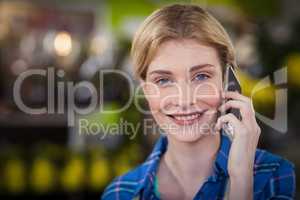 Female florist talking on mobile phone