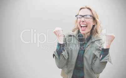 Composite image of pretty blonde cheering