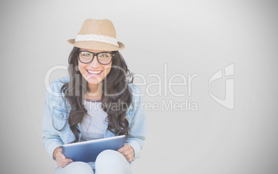 Composite image of brunette with tablet pc