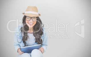 Composite image of brunette with tablet pc