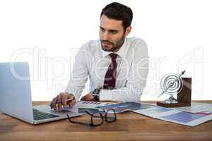 Businessman working on laptop in office