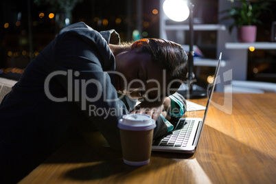 Businesswoman sleeping while working in office