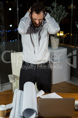 Frustrated businessman working in office