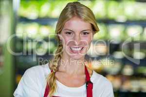 Smiling staff in supermarket