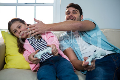 Father and daughter playing video game