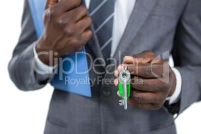 Mid section of businessman holding keys