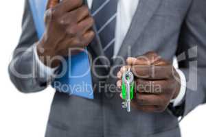 Mid section of businessman holding keys