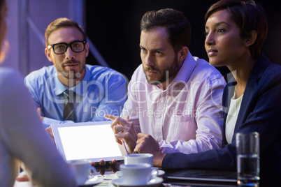 Businessman discussing on digital tablet with his colleagues